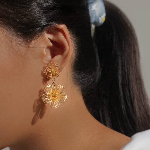 On model, gold Carnation Drop Earrings