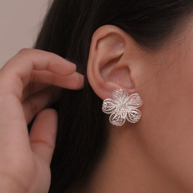 On model, silver Carnation stud earrings
