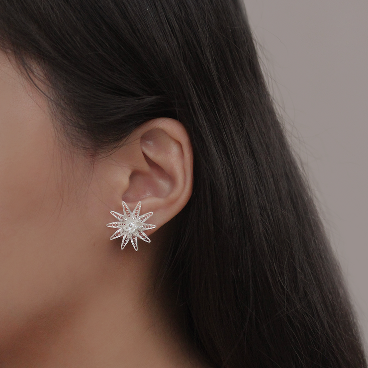 On model, silver Dasyanas stud earrings