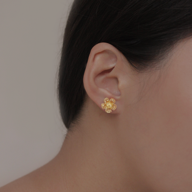 On model, Gold Gumamela stud earrings