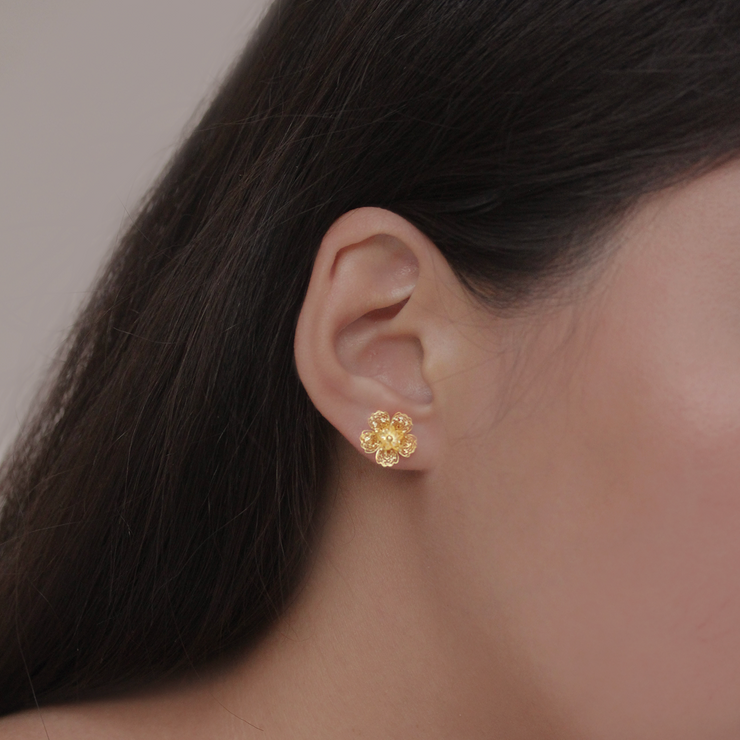 On model, Gold small Gumamela stud earrings