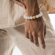 worn on wrist, white beaded bracelet with gold bead