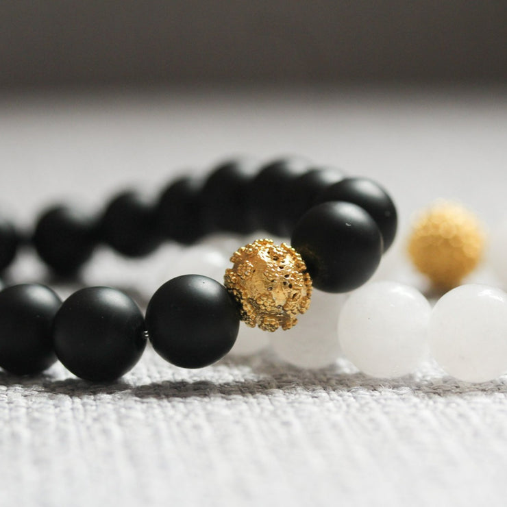 Amami black beaded bracelet with gold bead