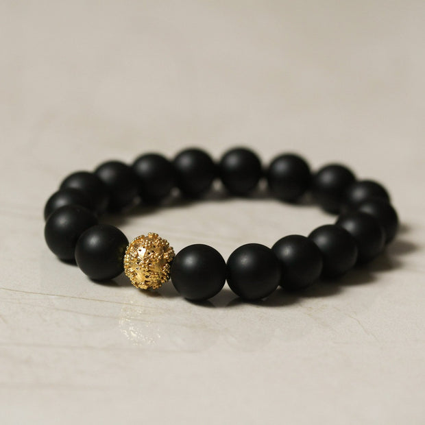 Black beaded bracelet with gold bead