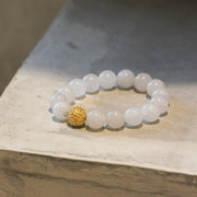 White bead bracelet with gold bead